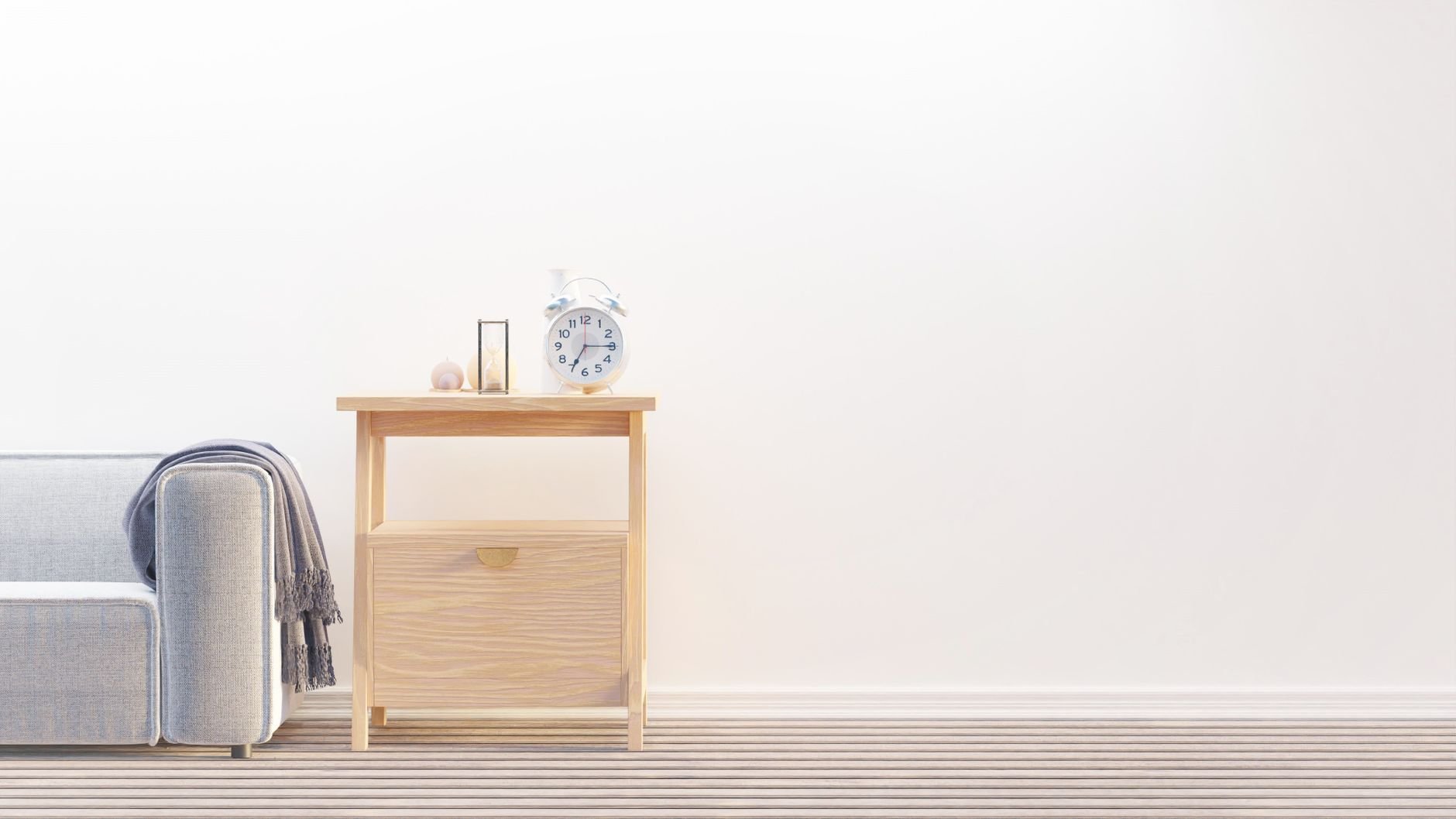 A minimalist living room with a wooden table, sofa, and warm natural light