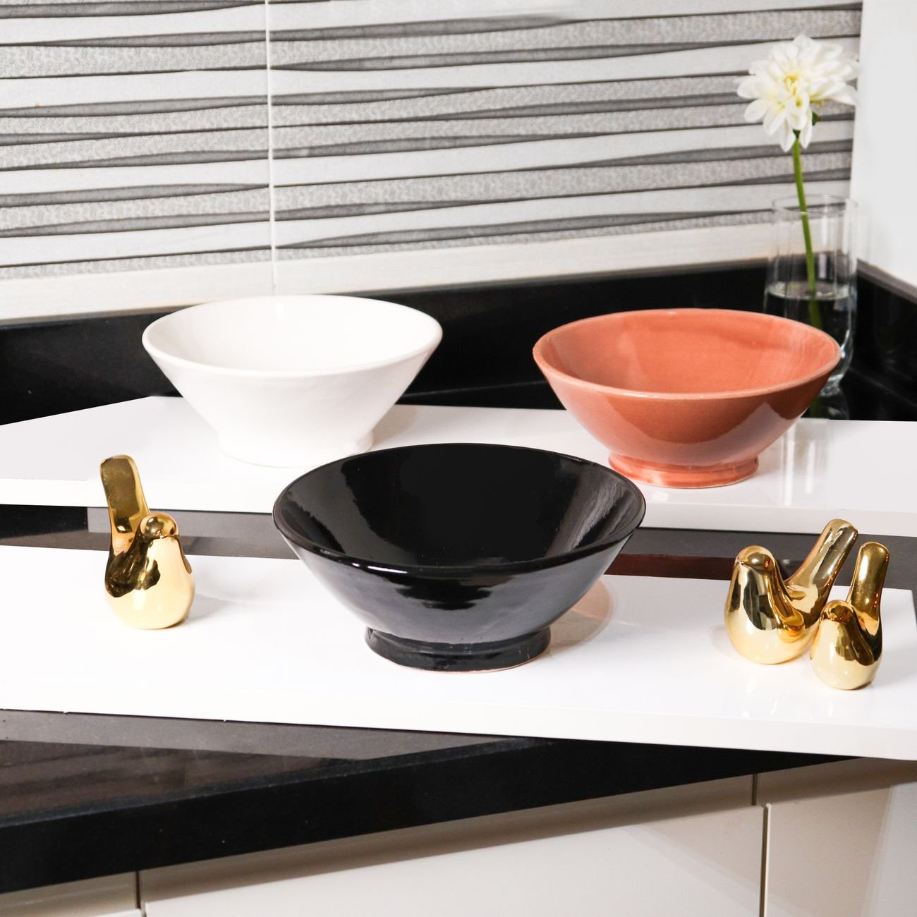 Stylish ceramic bowls in warm terracotta tones on a kitchen counter